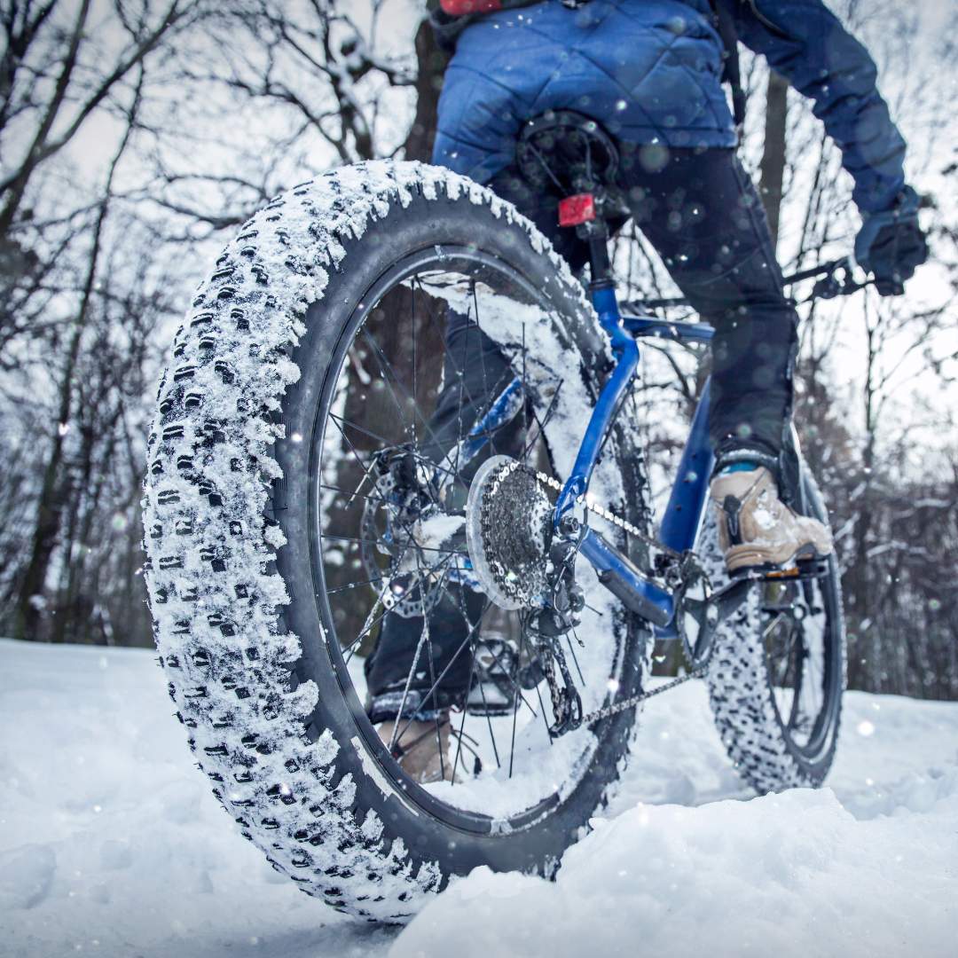A person biking through the snow.